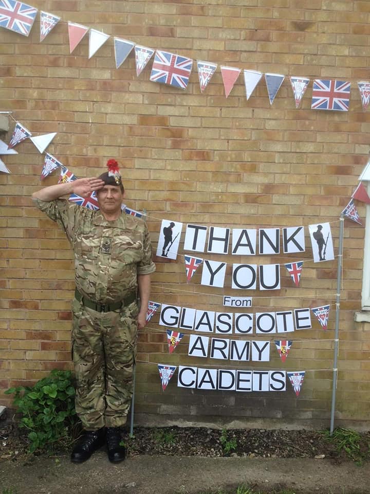 Adult Volunteer salutes for VE Day