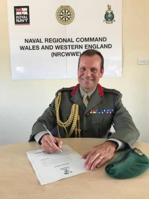 Brigadier Fraser, Royal Marines, signs the Armed Forces Covenant