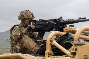 Unit member in armed position on Jackal 2 vehicle