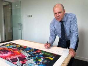 Colonel Maybery signing the print