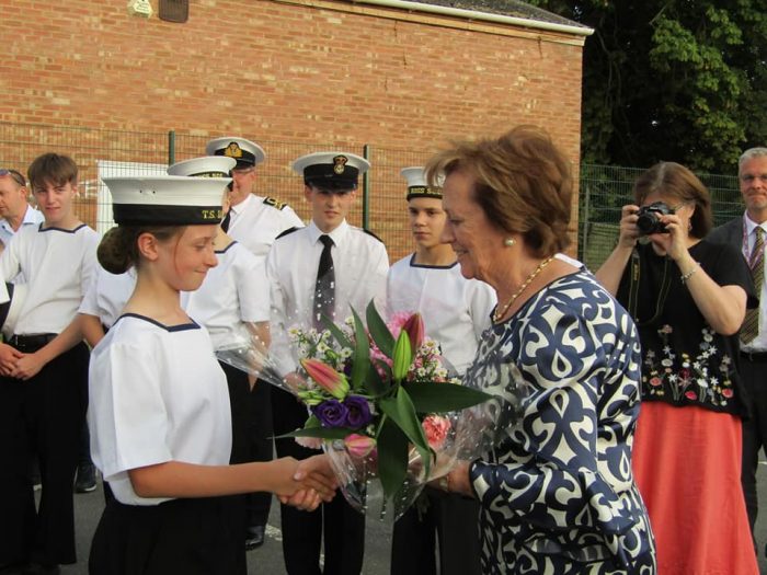 OC Bella presenting flowers as a gift, whilst in her uniform