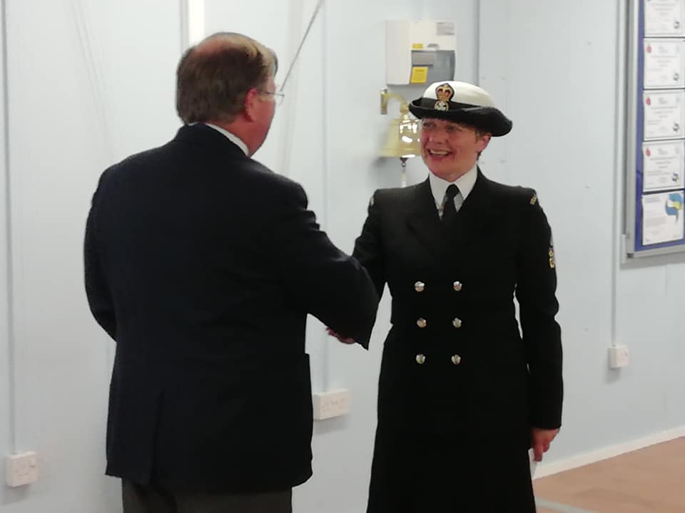 Sub Lieutenant Bumpstead in her uniform shaking hands