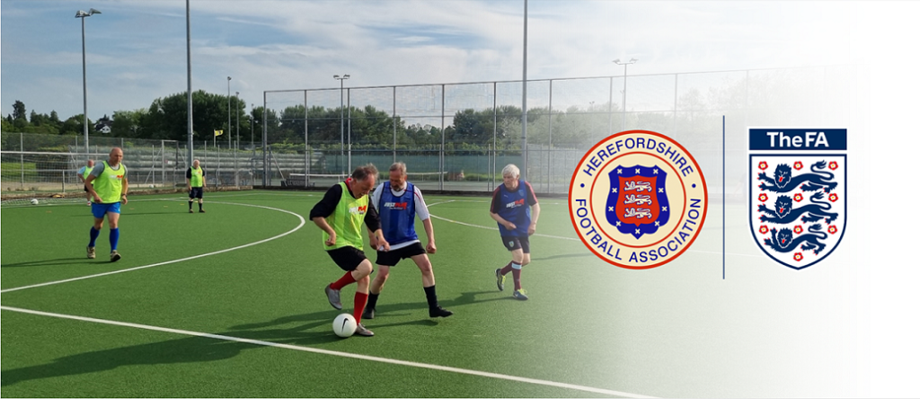 Three men are playing football at Herefordshire walking football's weekly sessions