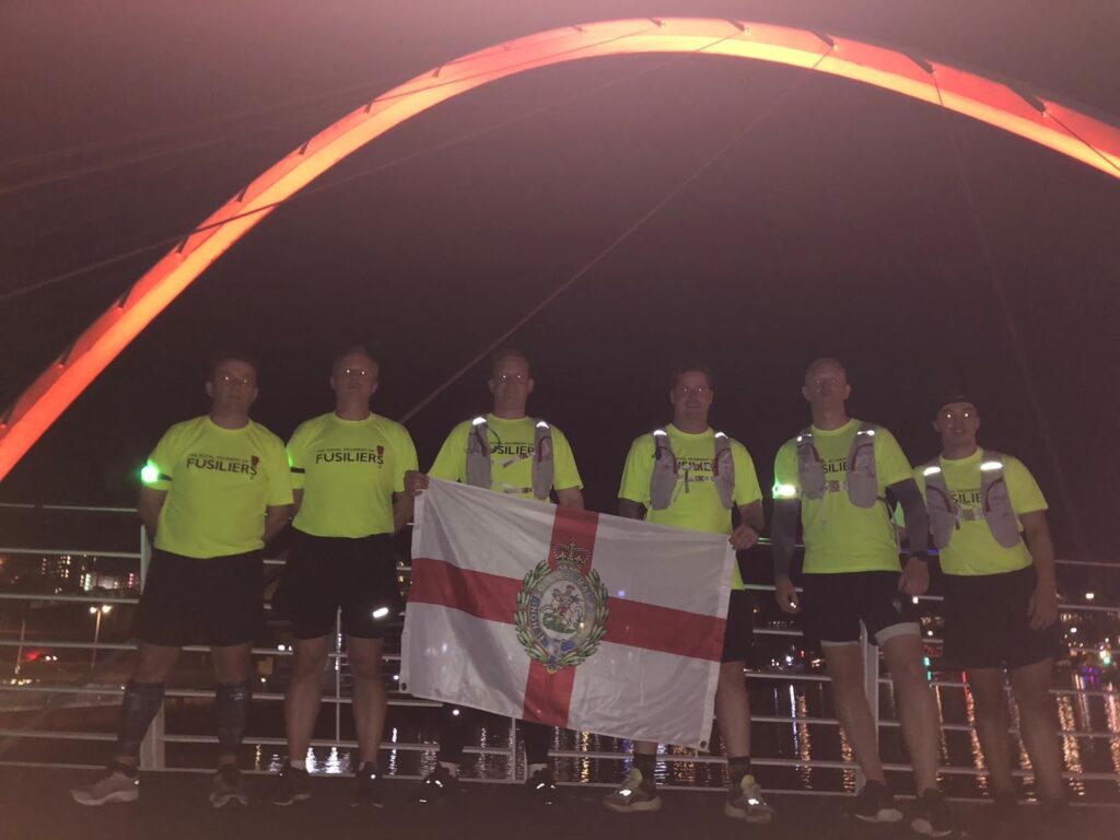 The 'Running Fusliers' pose for the camera on the Millenium Bridge in Newcastle