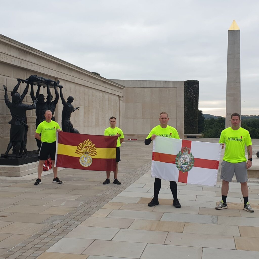 The 'Running Fusiliers' team pose with their regiment's flags at the National Memorial Arboretum, which was one of the landmarks they passed through on their 300 mile run