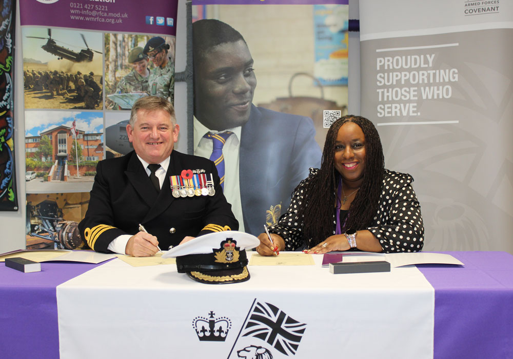 Commander Henaghen and Deputy Head of Primary, Michelle Grannell, sign the Armed Forces Covenant