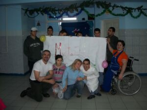 WO2 David Hill and Sarah at the orphanage in Romania, pictured with the children and adults