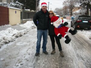 WO2 David Hill and Sarah in a snowy Romania, with Sarah holding a cuddly toy Santa