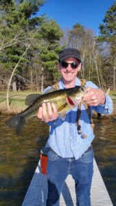 Capatin Crisp holding the Bass he caught.