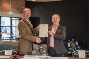 Colonel Chris Ledsham and Steve Morris holding the Armed Forces Covenant.