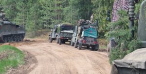 Vehicles with equipment travelling on the road.