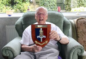 Harold with the coat of arms gift.