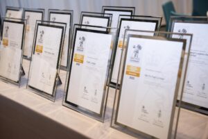 Awards lined up on table.