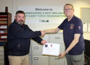 Mick receiving his commanders coin from Major Walker