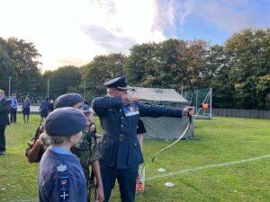 Group Captain Roger Simon trying his hand at Archery.