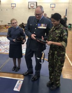 Group Captain Roger Simon with two cadets.