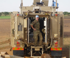 Sergeant Shotton with military vehicle.