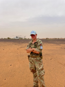 Sergeant Shotton with helicopter in the background,