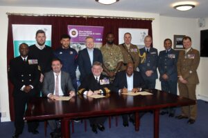 Group photograph of Basketball club members and military personnel.