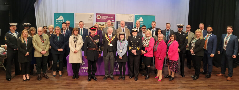 Representatives from each of the Summit Learning Trust Academies stand grouped together in front of display banners, smiling for the camera. Included in the group of representatives from West Midlands Lieutenancy, the Mayor, the Royal Navy and West Midland - all in uniform.