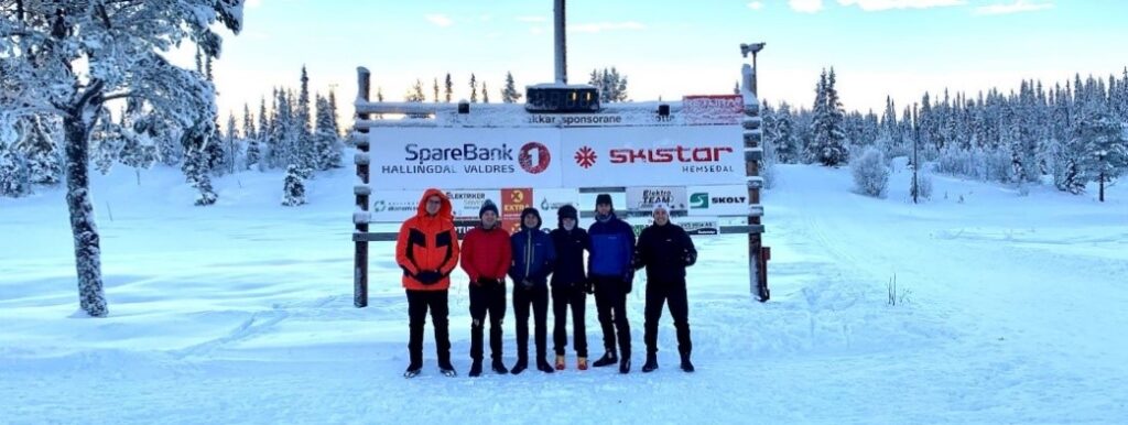 Teammembers in front of event signage.