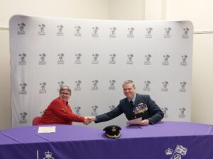 Ruby Hartshorn and Group Captain Andy Baron shaking hands