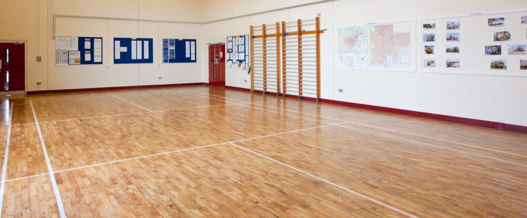 Drill hall - empty room with wooden floor.