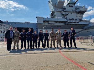 Cadets and adult volunteers stood alongside HMS Queen Elizabeth.