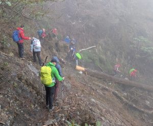 Reservists descending down rough mountain terrain.
